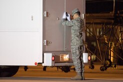 Senior Airman Joshua Fernandez closes the door of the transfer vehicle during a dignified transfer Nov. 13, 2011, at Dover Air Force Base, Del. Fernandez has served in a variety of positions inside the Charles C. Carson Center for Mortuary Affairs during his deployments in support of the sacred mission. Fernandez is assigned to the 512th Memorial Affairs Squadron at Dover AFB. (U.S. Air Force Photo/Adrian Rowan)
