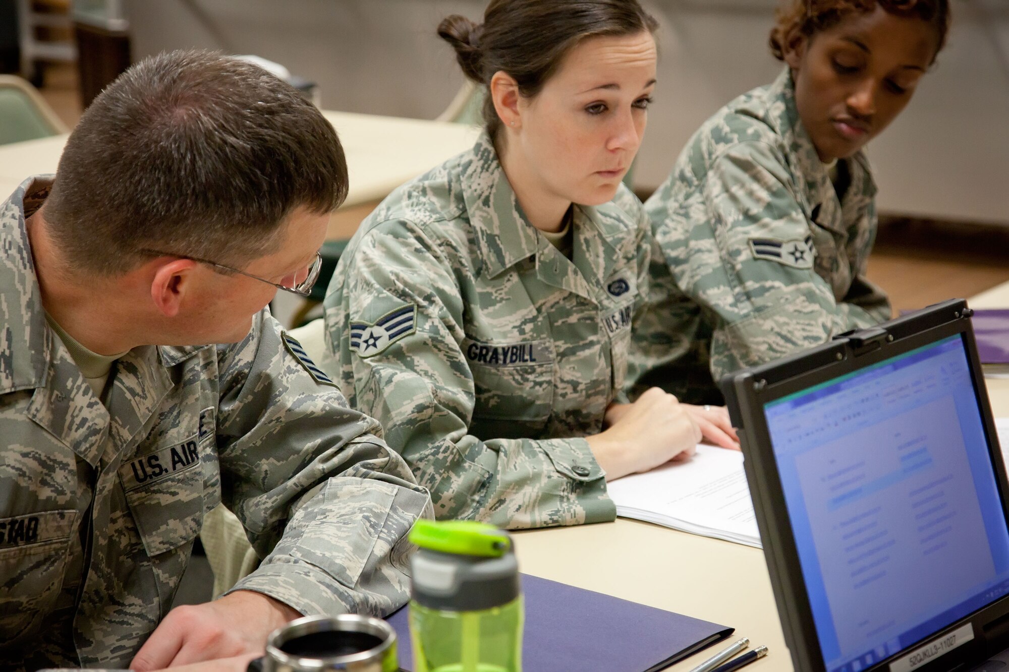 Senior Airman Stephanie Graybill is quizzed by her fellow Airmen Tech. Sgt. Jim Harstad and Airman 1st Class Fardosa Corbin from the 934th Airlift Wing as they participate in Personnel Support for Contingency Operations training over the Unit Training Assembly weekend.  After nine months of training, they test what they've learned in a hands on excercise of real life situations, from lost ID tags to earning medals, in a simulated deployed location.  (U.S. Air Force Photo/Shannon McKay)