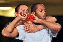 MINOT AIR FORCE BASE, N.D. -- Team Minot security forces members practice distinct defensive tactics of Krav Maga, an Israeli system of hand-to-hand combat, as part of a week-long training seminar. The program is designed to teach a large amount of techniques in a short time and can be performed by anybody regardless of age, height or weight. (U.S. Air Force photo/Senior Airman Brittany Y. Auld)
