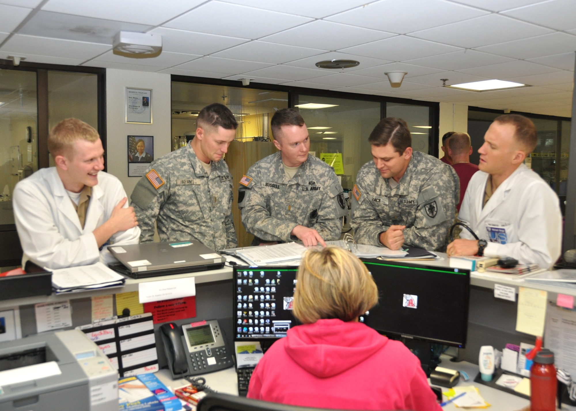 Army 2nd Lts. Timothy Russell, Jason Zack and Darren Hyams and Navy Ensigns Michael Berge and Robert Blackmon receive information at the Intensive Care Unit nurses’ station Oct. 11, 2012, at the Keesler Hospital, Keesler Air Force Base, Miss. The students are part of a new Uniformed Services University of the Health Sciences rotation at the 81st Medical Group.  (U.S. Air Force photo by Steve Pivnick)