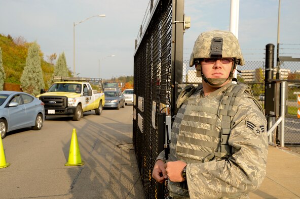 U.S. Air Force Senior Airman Allen Russell, 911th Security Forces Squadron, stands by for word to reopen the main gate during a barrier and anti-terrorism exercise at the 911th Airlift Wing, Oct. 17, 2012. During the exercise, Allegheny County authorities worked with the 911th in responding to a simulated threat. Practicing real world scenarios with the partnership of local law enforcement helps to maintain readiness and better mitigate risk for real world threats. (U.S. Air Force photo by Tech. Sgt. Christine Jones/Released)