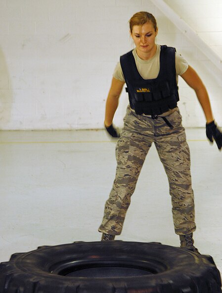 Staff Sgt. Emily Strope 178th Communications Flight rolls a tire as part of a fireman endurance test  on Springfield Air National Guard Base Ohio, October 13, 2012.  Strope took the test as part of the 178th Fighter Wing fitness expo . (U.S. Air Force Photograph by Master Sgt. Seth Skidmore/released) 