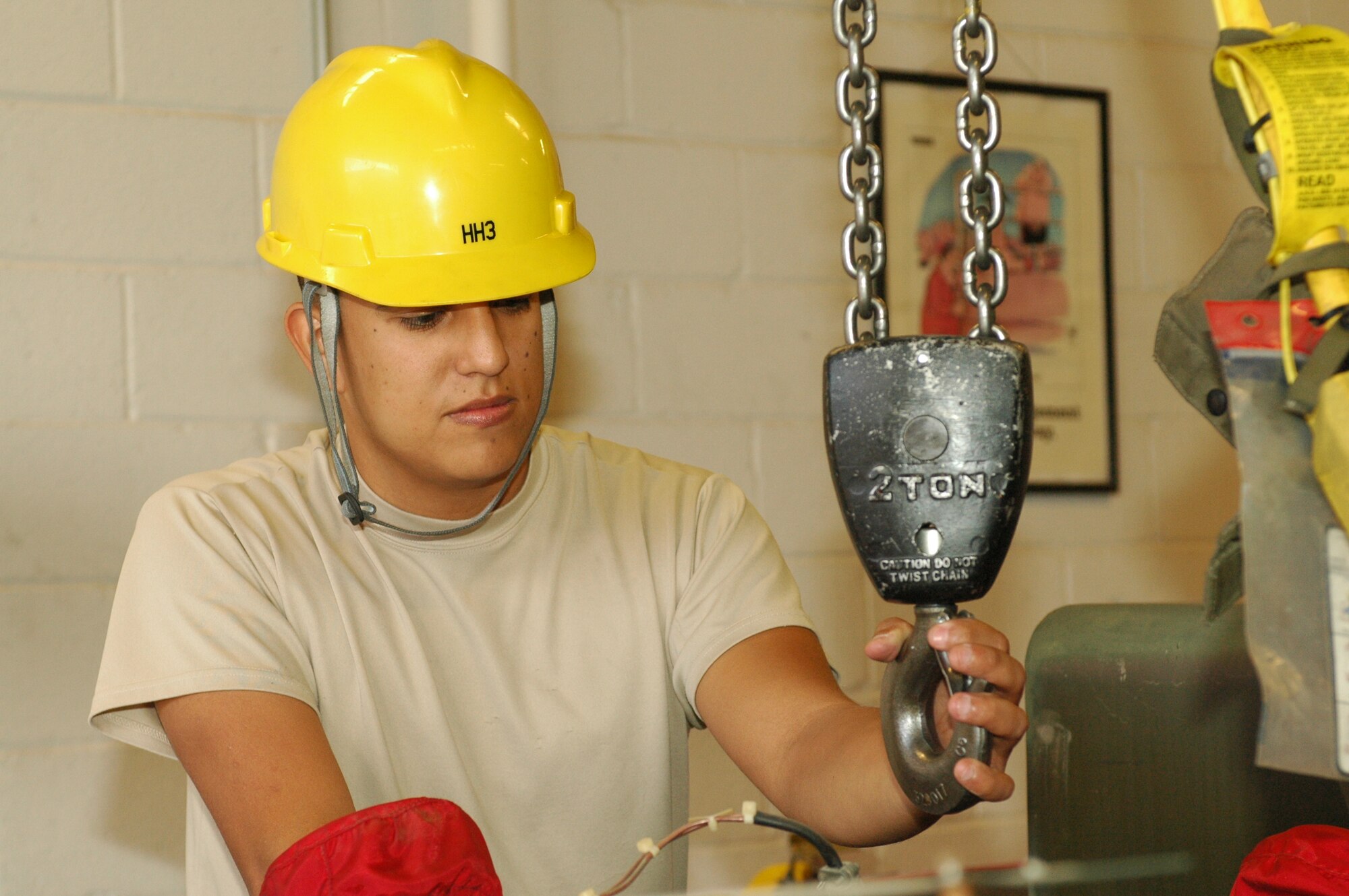 Senior Airman Esequiel Borunda, an Aerospace Ground Equipment technician with the 162nd Fighter Wing, attaches a lift to an engine before removing it from a piece of AGE. (U.S. Air Force photo by Staff Sgt. Heather Davis/Released)