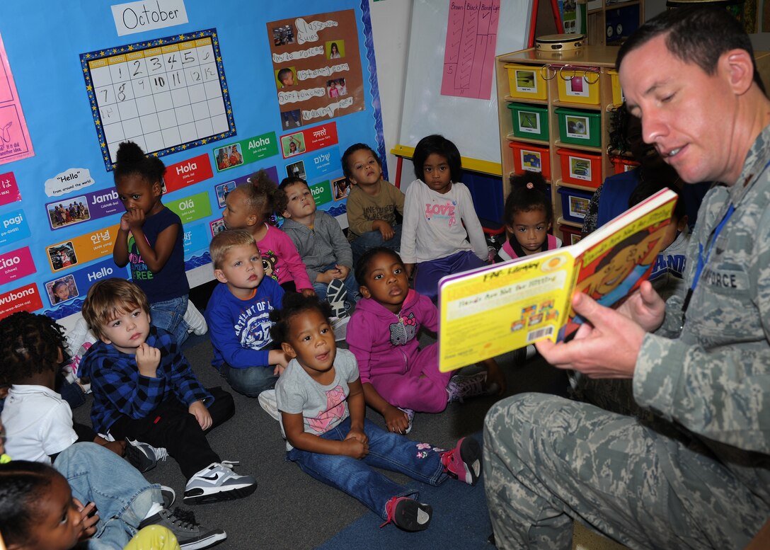 U.S. Air Force Maj. Mike Zink, Air Combat Command Directorate of Communications Warfighter Systems Integration chief, reads a book to children at the Child Development Center at Langley Air Force Base, Va., Oct. 17, 2012. Readers talked to children about using words when they are angry, instead of hitting, during Domestic Violence Awareness Month. (U.S. Air Force photo by Airman 1st Class Teresa Aber/Released)