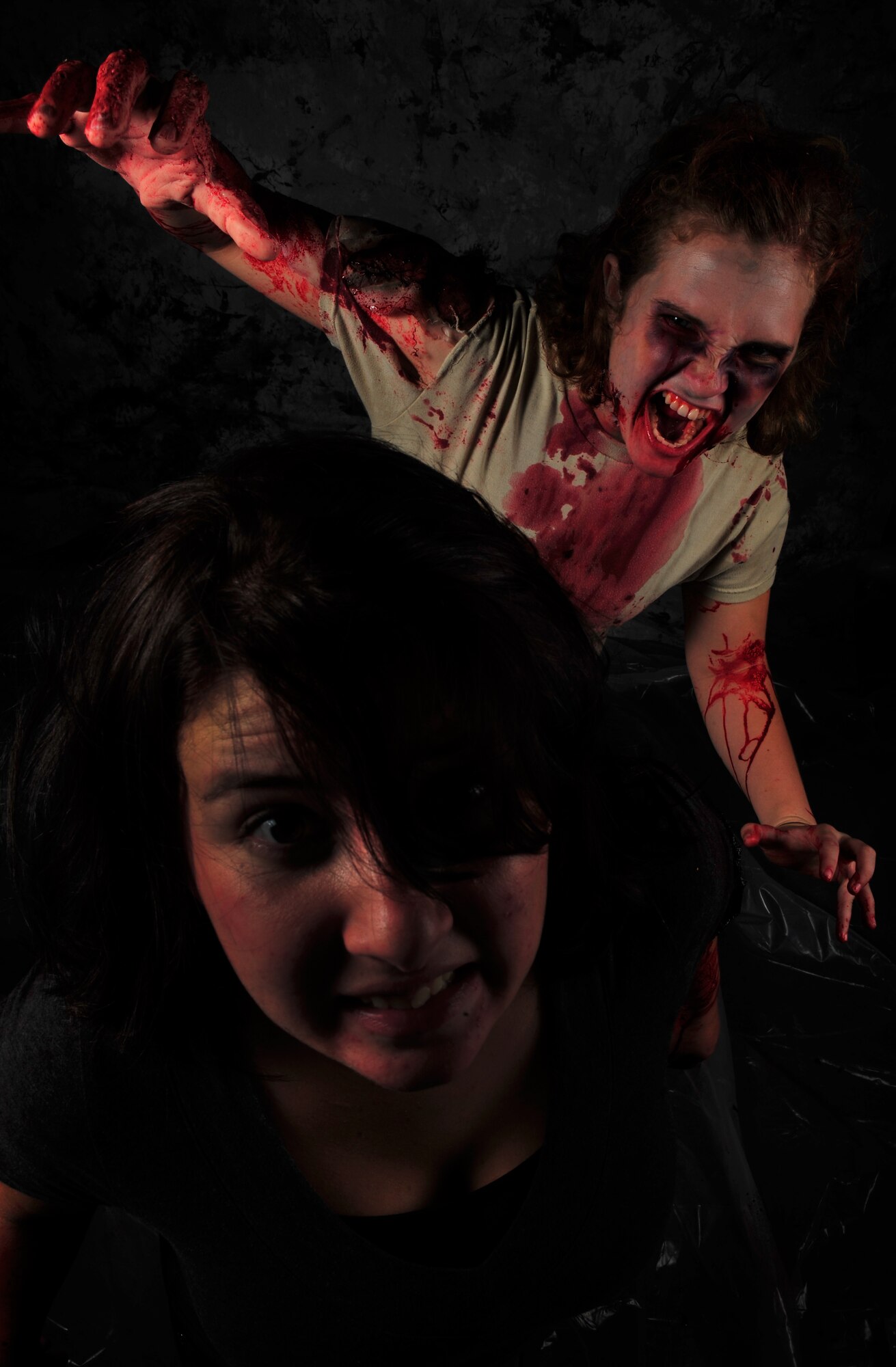 Air Commandos transform into their undead alter egos in preparation for the upcoming Zombie 5K/run obstacle course scheduled to take place at the Whispering Winds Golf Course, Oct. 19, at Cannon Air Force Base, N.M. The event, hosted by Cannon’s Air Force Sergeant’s Association, challenges human runners to navigate a 3.2 mile course while evading the clutches of the zombie horde that will be crawling, lumbering and sprinting after them. (U.S. Air Force illustration/Airman 1st Class Ericka Engblom)