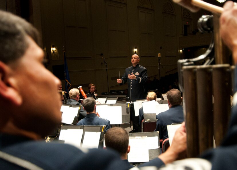 NASHUA, N.H. -- Capt. David Alpar, U. S. Air Force Band of Liberty commander, conducts the band during an evening concert at the Keefe Auditorium here Oct. 13. The Band of Liberty Concert Band is a select group of profesional Airmen musicians who support the global Air Force mission by providing musical products and services for official military, recruiting, and community relations events. (U.S. Air Force photo by Mark Wyatt)