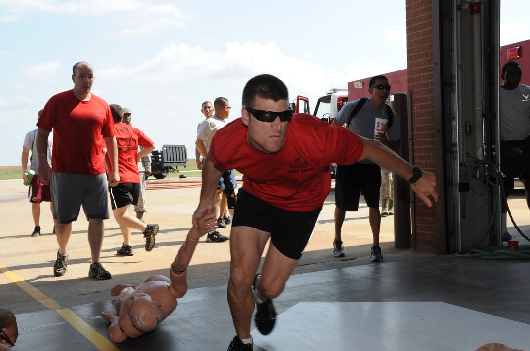 EOD Preliminary School instructors from the 366th Training Squadron participate in the dummy drag event Oct. 12, 2012, at the 3rd annual Fire Prevention Olympics. The event was hosted by the Sheppard Air Force Base fire department as part of Fire Prevention week.  (US Air Force photo/Felton Joshua Jr.)