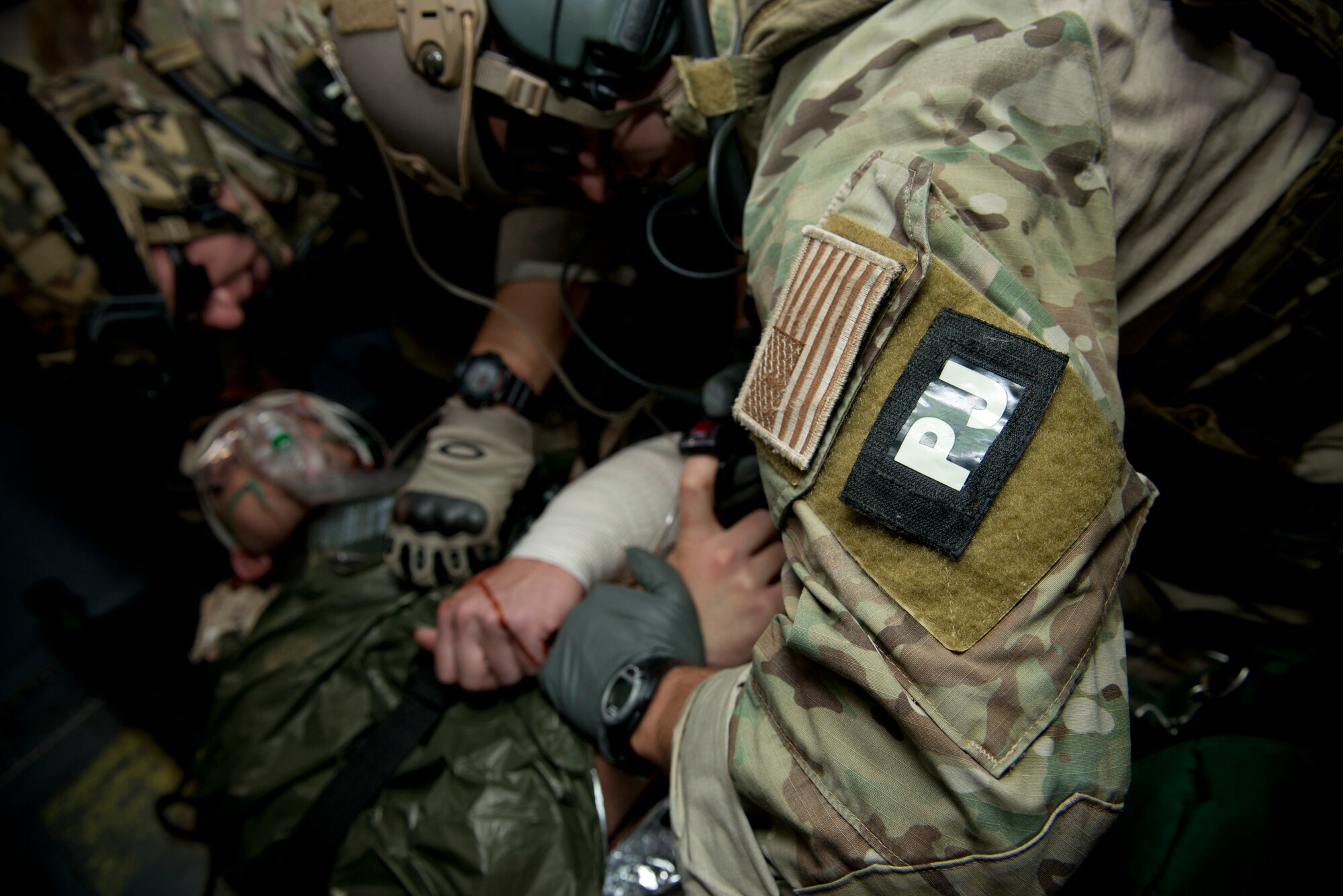 U.S. Air Force pararesuemen from the 38th Rescue Squadron perform simulated medical procedures at Moody Air Force Base, Ga., Oct. 5, 2012. The pararescuemen communicated with the patient to ensure he remained awake and responsive. (U.S. Air Force photo by Senior Airman Douglas Ellis/Released)
