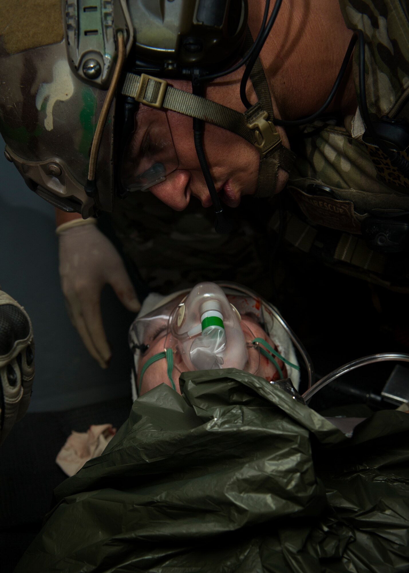 A pararescueman from the 38th Rescue Squadron talks with a patient while performing simulated medical procedures at Moody Air Force Base, Ga., Oct. 5, 2012. The pararescueman communicated with the patient to ensure that he remained awake and responsive. (U.S. Air Force photo by Senior Airman Douglas Ellis/Released)
