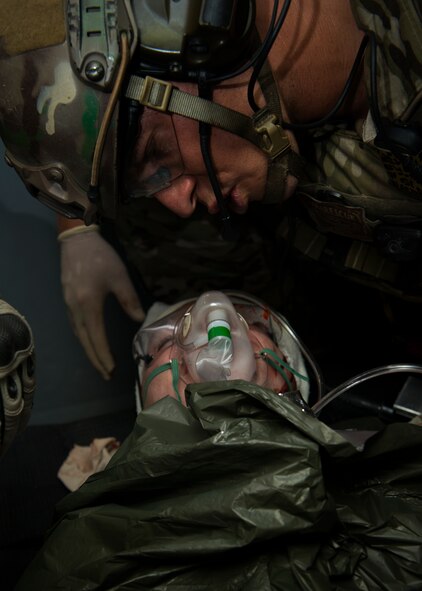 A pararescueman from the 38th Rescue Squadron talks with a patient while performing simulated medical procedures at Moody Air Force Base, Ga., Oct. 5, 2012. The pararescueman communicated with the patient to ensure that he remained awake and responsive. (U.S. Air Force photo by Senior Airman Douglas Ellis/Released)
