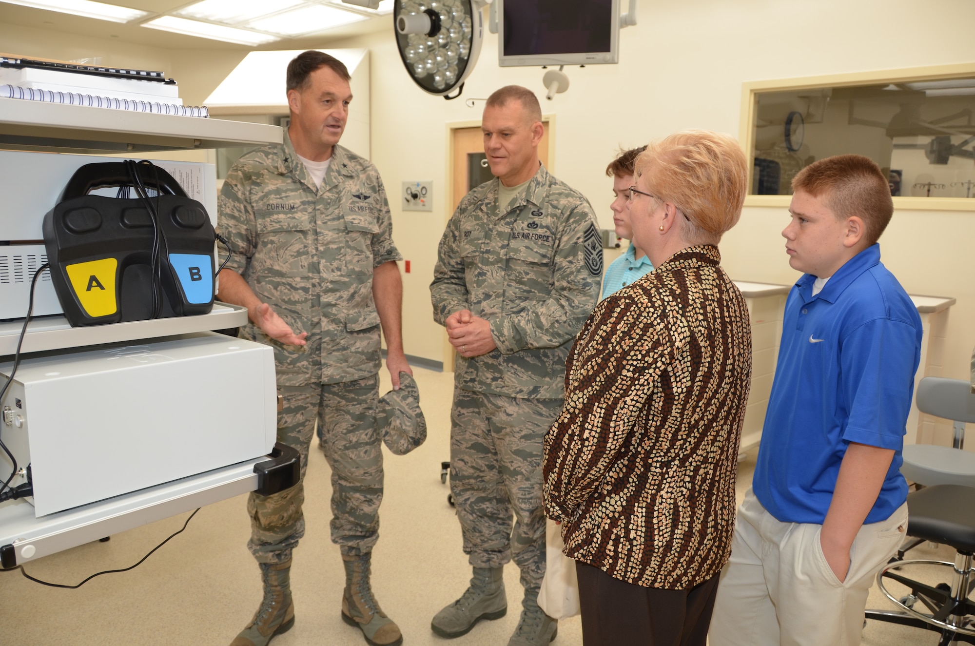Brig. Gen. (Dr.) Kory Cornum, 81st Medical Group commander, left, describes operating room equipment to Chief Master Sgt. of the Air Force James Roy and his family during the Roys’ visit to the Keesler Hospital’s new Back Bay Tower Oct. 16, 2012.  Roy’s wife Paula and twin 12-year-old sons Colby and Caleb also toured other areas of the hospital.  Mrs. Roy was secretary to several 81st Aerospace Medicine Squadron commanders during the chief’s tour at Keesler in the late 90s and Colby and Caleb were born in the hospital. (U.S. Air Force photo by Steve Pivnick)