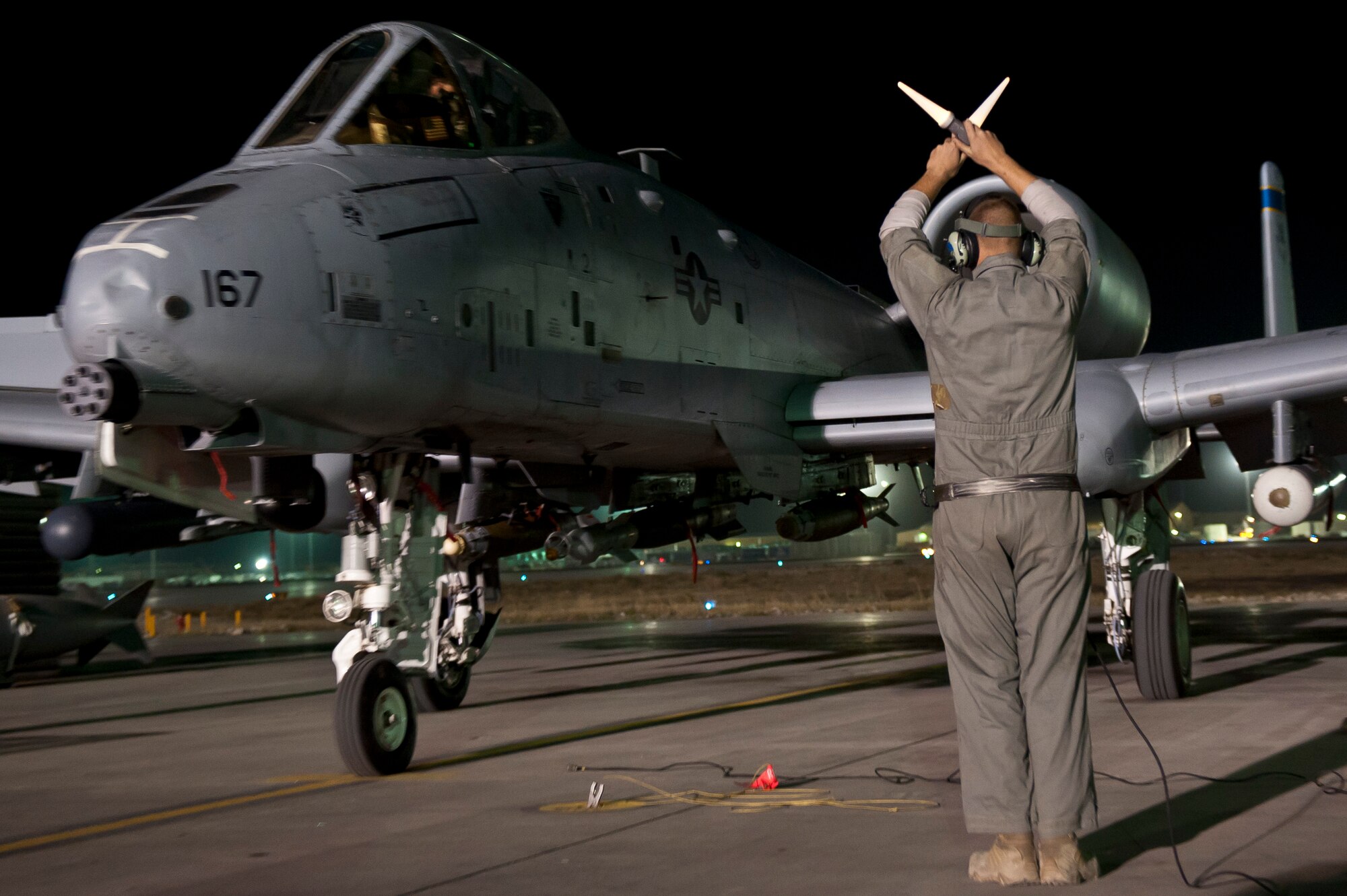 A maintainer with the 455th Expeditionary Aircraft Maintenance Squadron, marshals a U.S. Air Force A-10 Thunderbolt II to its parking spot at Bagram Airfield, Afghanistan Oct. 16, 2012. Bagram’s A-10s fly daily to provide constant close-air support to NATO and Afghan ground forces operating in Afghanistan. (U.S. Air Force Photo/Capt. Raymond Geoffroy)