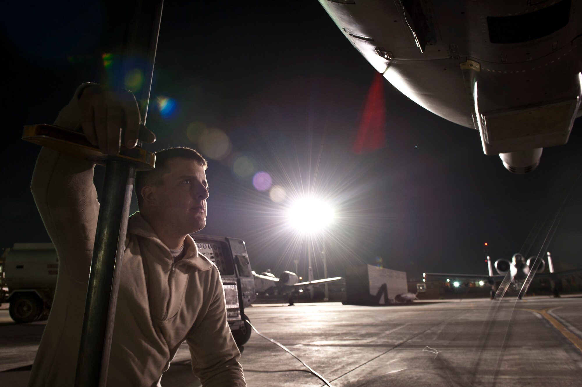 A1C Joseph Jordan, a maintainer with the 455th Expeditionary Aircraft Maintenance Squadron, observes a fellow maintainer working on a U.S. Air Force A-10 Thunderbolt II at Bagram Airfield, Afghanistan Oct. 16, 2012. Bagram maintainers work around the clock to keep their “Warthogs” ready to fly close air support missions in support of coalition ground forces. (U.S. Air Force Photo/Capt. Raymond Geoffroy)