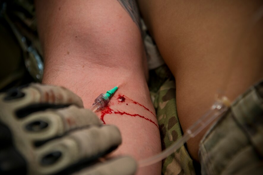 U.S. Air Force Staff Sgt. Eric Mathieson, 38th Rescue Squadron pararescueman, performs simulated medical procedures at Moody Air Force Base, Ga., Oct. 5, 2012. One of the procedures was to use an intravenous system on the patient. (U.S. Air Force photo by Senior Airman Douglas Ellis/Released)
