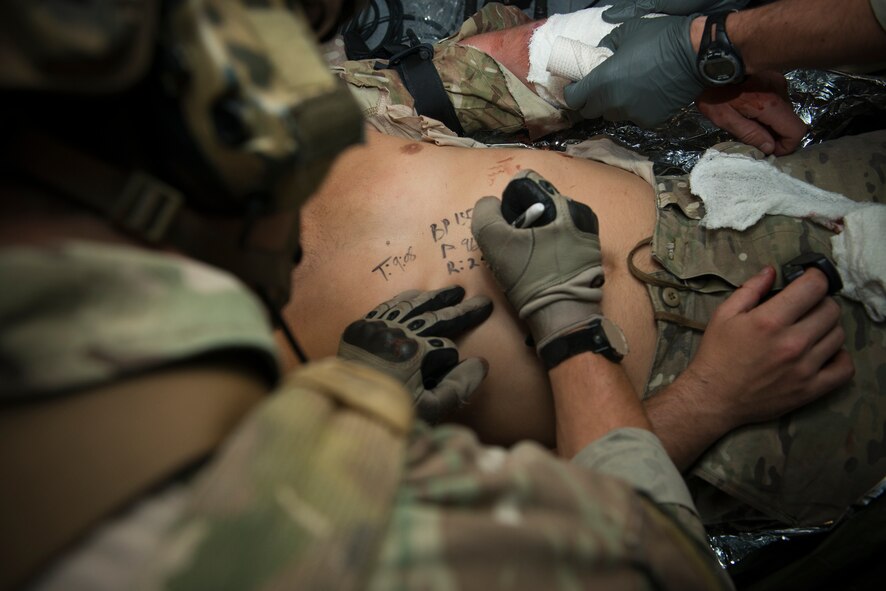 U.S. Air Force Staff Sgt. Eric Mathieson, 38th Rescue Squadron pararescueman, writes information on a patient’s body while performing simulated medical procedures at Moody Air Force Base, Ga., Oct. 5, 2012. The information included the patient’s pulse, blood pressure, heart rate and the time that a tourniquet was placed on his leg. (U.S. Air Force photo by Senior Airman Douglas Ellis/Released)
