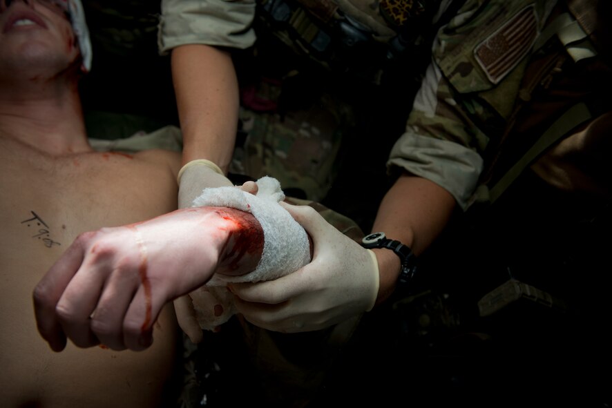 A pararescueman from the 38th Rescue Squadron performs simulated medical procedures at Moody Air Force Base, Ga., Oct. 5, 2012. The pararescuman wrapped the patient’s wound and attempted to stop the bleeding. (U.S. Air Force photo by Senior Airman Douglas Ellis/Released)
