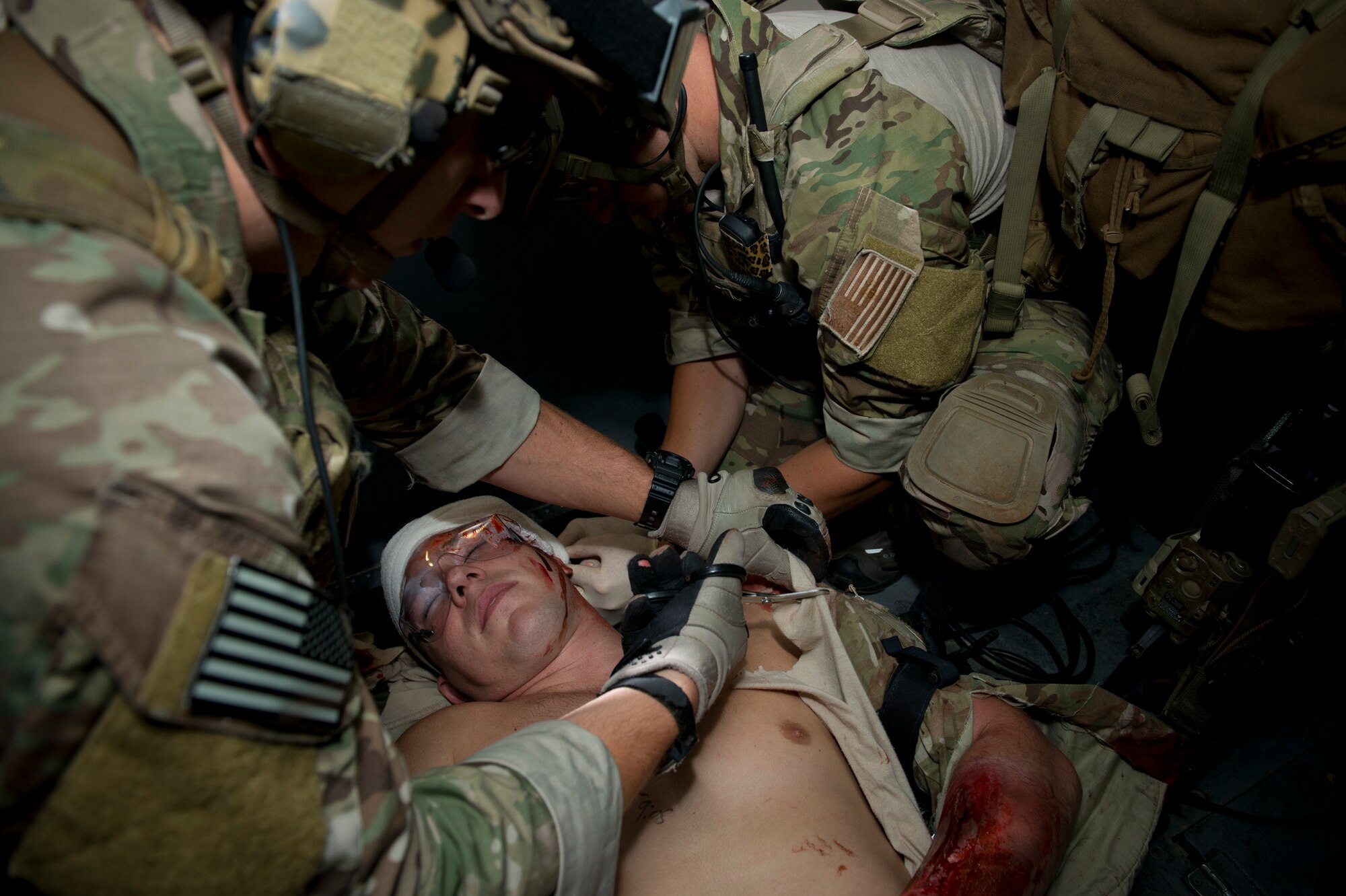 U.S. Air Force pararescuemen from the 38th Rescue Squadron perform simulated medical procedures at Moody Air Force Base, Ga., Oct. 5, 2012. The Airmen removed some of the patient’s clothing to properly treat the wounds. (U.S. Air Force photo by Senior Airman Douglas Ellis/Released)
