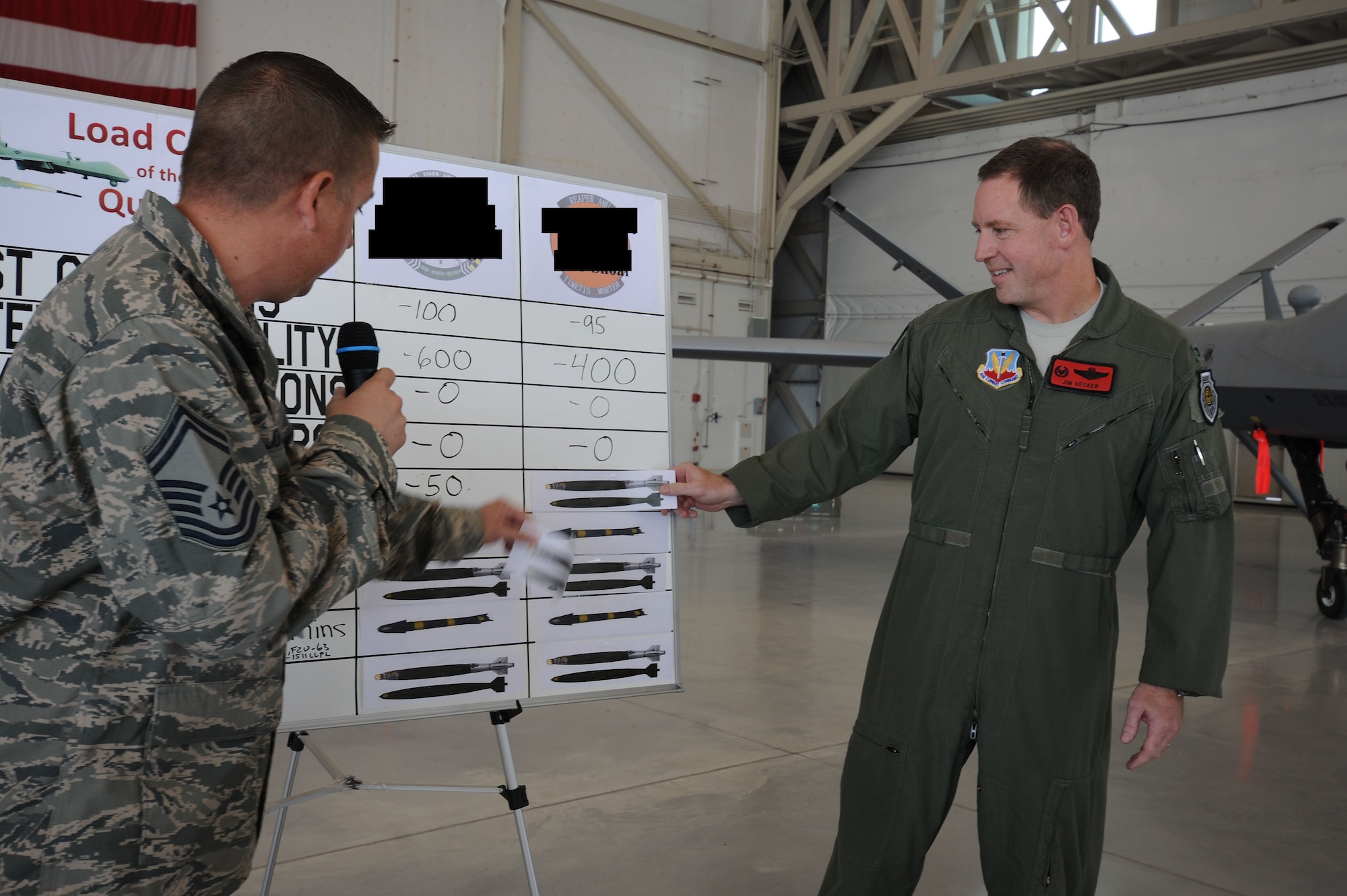 Col. James Hecker, 432d Wing/432d Air Expeditionary Wing commander, announces the 432d Aircraft Maintenance Squadron Reaper aircraft maintenance unit as the winners of the 432d Maintenance Group load crew of the quarter competition, Oct. 5, 2012, at Creech Air Force Base, Nev.  The three-man weapons loading teams are evaluated on a variety of technical aspects to include safety, use of tools, technical order violations and overall time. (U.S. Air Force photo by 432d Wing/432d Air Expeditionary Wing Public Affairs)