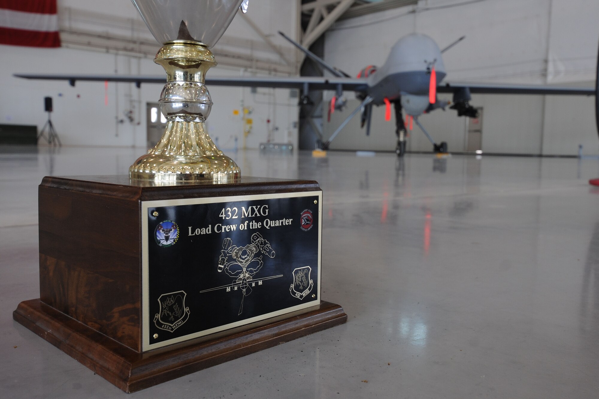 The 432d Maintenance Group award stands to be claimed prior to the start of the 432d MXG load crew of the quarter competition, Oct. 5, 2012, at Creech Air Force Base, Nev. The competition brings together two three-man weapons loading teams from Tiger and Reaper aircraft maintenance units at Creech to compete against each other for top honors. (U.S. Air Force photo by 432d Wing/432d Air Expeditionary Wing Public Affairs)
