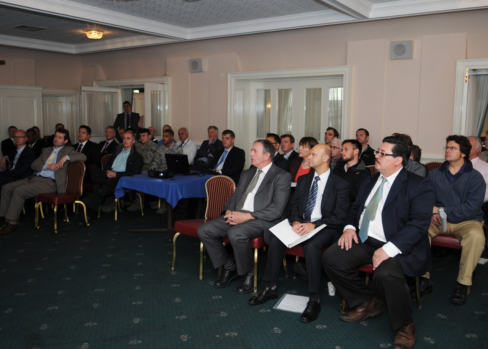 Members of RAF Mildenhall, RAF Alconbury, RAF Lakenheath and energy industry representatives listen to a briefing during the inaugural Energy Awareness Symposium Oct. 17, 2012, at RAF Mildenhall, England.  The purpose of the symposium was to bring military members and industrial experts together to discuss future opportunities to further energy- and water-saving initiatives. (U.S. Air Force photo by Staff Sgt. Tabitha Lee/Released)