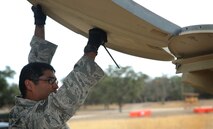 TSgt Fabian Robles, assigned to the 15th Air Mobility Operations Squadron , works to construct the Deployed AMC Communications Element at the U.S. Army Combat Support Training Center at Fort Hunter Liggett, Calif. during Exercise Soaring Angel.  Members of the 621st Contingency Response Wing and the 129th Rescue Wing, partnered to get crucial training at the installation’s Schoonover LZ. (U.S. Air Force Photo/MSgt Stan Parker)
