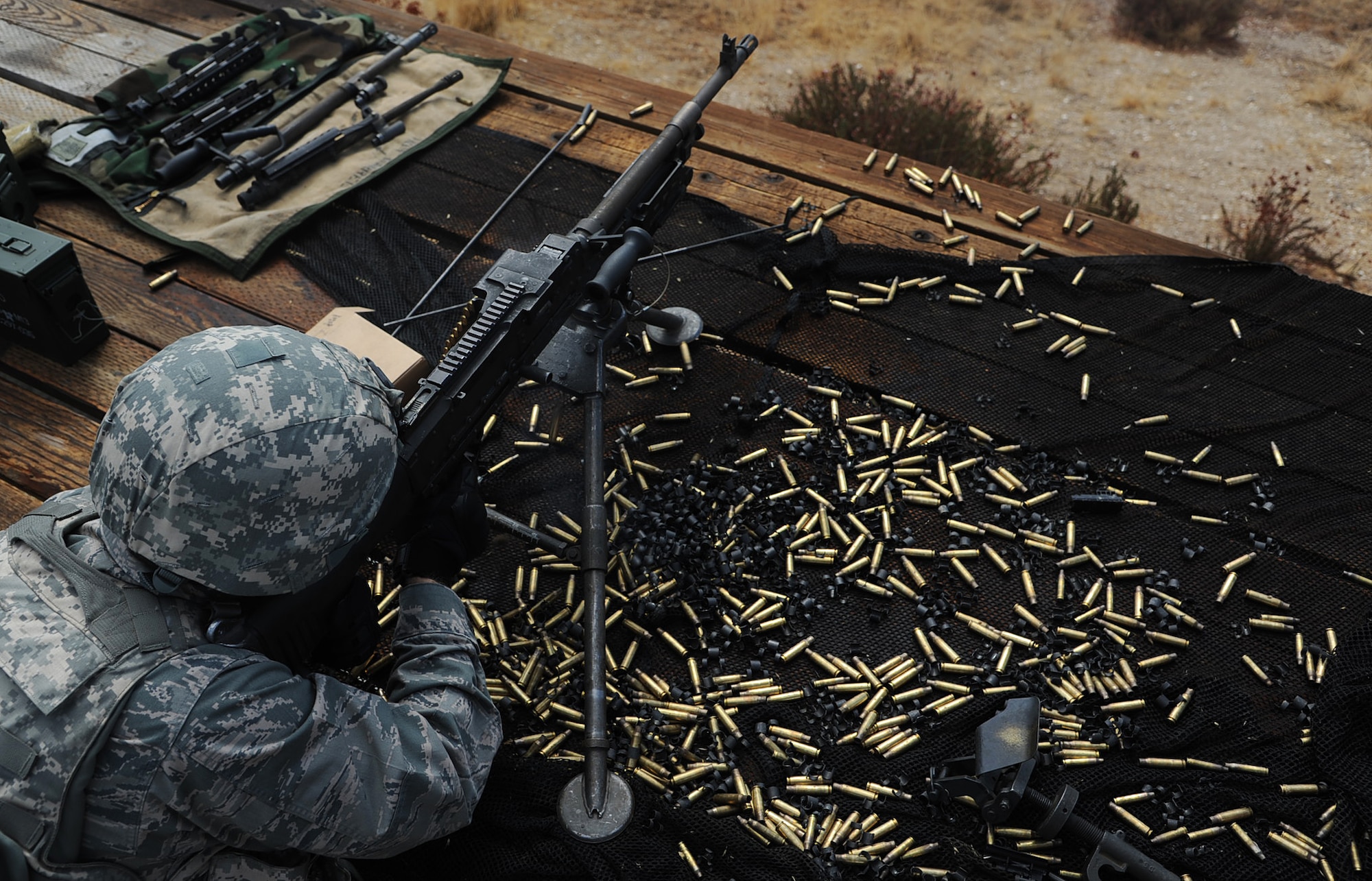 A member of the 621st Contingency Response Wing fires the M-249 Bravo downrange during weapon’s qualification at the U.S. Army Combat Support Training Center firing range at Fort Hunter Liggett, Calif. during Exercise Soaring Angel.  Members of the 621st Contingency Response Wing and the 129th Rescue Wing, partnered to get crucial training at the installation’s Schoonover LZ. (U.S. Air Force Photo/MSgt Stan Parker)