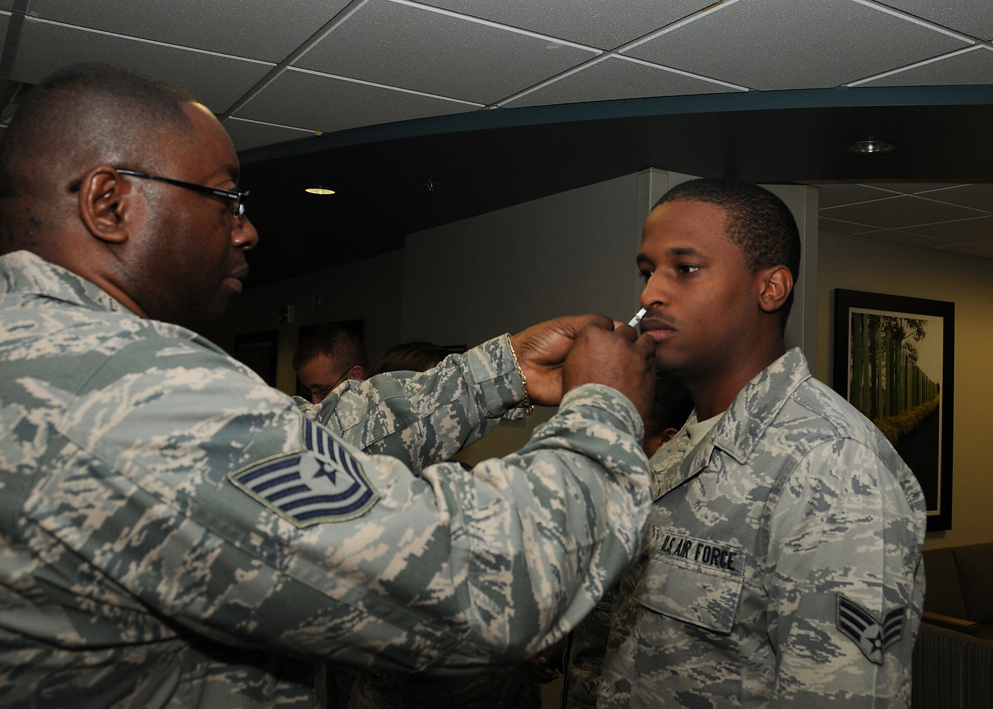 Senior Airman Kofi Gillespie, 512th Aircraft Maintenance Squadron, receives a flu vaccine Oct. 13, 2012, at the base clinic, Dover Air Force Base, Del. During the October unit training assembly, 512th Airlift Wing medical teams administered 828 flu vaccinations in preparation for the flu season. (U.S. Air Force photo by Erika Brooke)