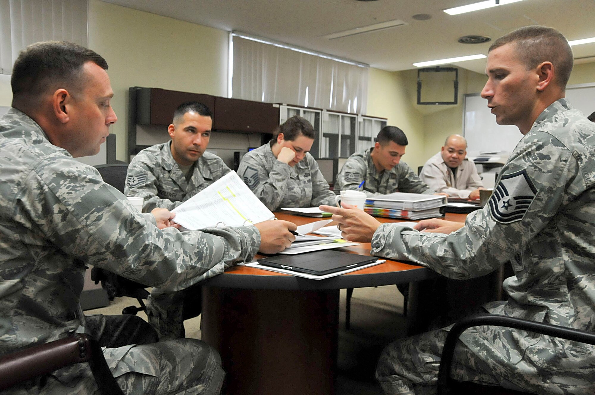 U.S. Air Force Master Sgt. Paul Gingras, 18th Security Forces Squadron superintendent of standardization and evaluations, answers questions about their continuity books to the inspector general during the consolidated unit inspection at Kadena Air Base, Japan, Oct. 16, 2012. This week, IG teams evaluated how the base follows Air Force regulations, checklists and operating procedures. (U.S. Air Force photo/Staff Sgt. Darnell T. Cannady)