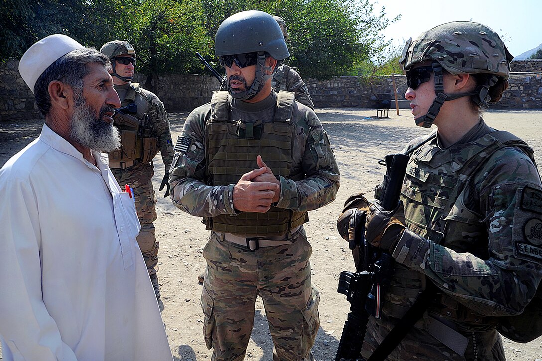 U.S. Navy Lt. j.g. Kimberly Herm, right, speaks to a school official at Nowabad School in Afghanistan's Kunar province, Oct. 13, 2012. Herm, an engineer, is assigned to Provincial Reconstruction Team Kunar.