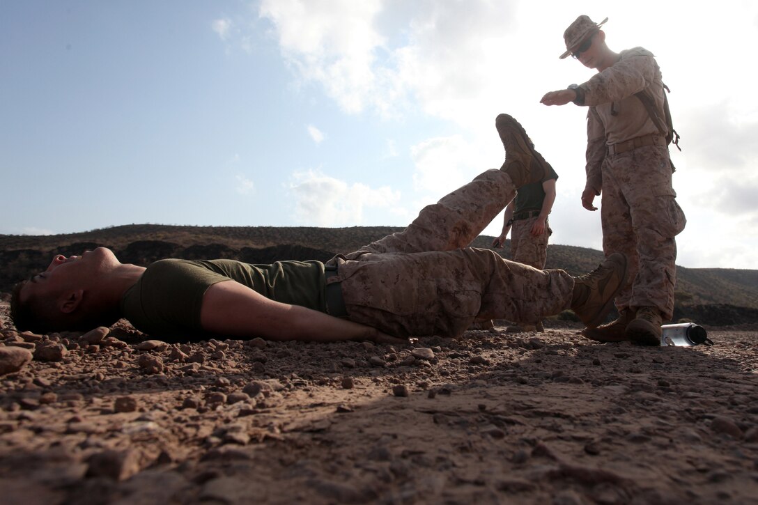 DJIBOUTI (Oct. 8, 2012) - A Marine with Bravo Company, Battalion Landing Team 1st Battalion, 2nd Marine Regiment, 24th Marine Expeditionary Unit, performs flutter kick exercises in a relay race while competing in the training force challenge in Djibouti, Oct. 8, 2012. The challenge was part of a three-week training force package, which paired Marines of Bravo Company with Marines of Combat Logistics Battalion 24, to gain a shared understanding of each other's roles in the Marine Corps Air Ground Task Force and refine their basic infantry skills in Djibouti's rugged terrain. The package comprised basic infantry skills, desert survival techniques, endurance courses and a simulated war. The 24th MEU is deployed with the Iwo Jima Amphibious Ready Group as a theater reserve and crisis response force in the U.S. Central Command and U.S. Navy's 5th Fleet area of responsibility. (Photo by Staff Sgt. Robert L. Fisher III)