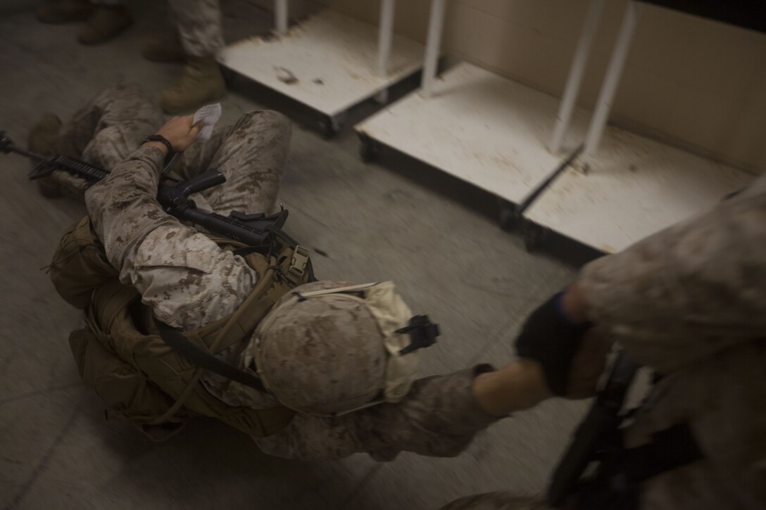 A simulated casualty with India Company, Battalion Landing Team (BLT) 3/2, 26th Marine Expeditionary Unit (MEU), is dragged to cover for immediate first aid during a raid at Marine Corps Base Camp Lejeune, N.C., Oct. 2, 2012. The company conducted a two-week vertical assault raid package with the Special Operation Training Group in order to help fulfill requirements from the 26th MEU’s mission essential task list. The 26th MEU is slated to deploy in 2013.