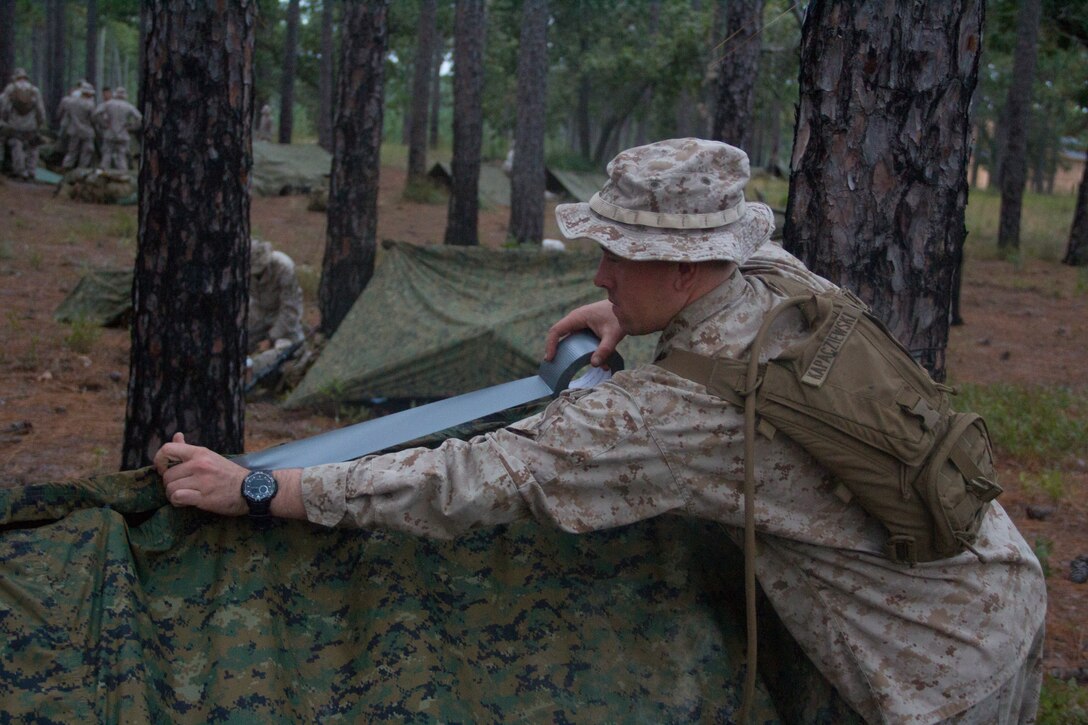 Pfc. Randy Kapacziewksi, infantry automatic rifle gunner with Company K, Battalion Landing Team (BLT) 3/2 from Bristol, Conn., currently reinforcing the 26th Marine Expeditionary Unit (MEU),reinforces his tent during the mechanized raid course at Camp Lejeune, N.C., Oct. 8, 2012. BLT 3/2 is one of the three reinforcements of 26th MEU, which is slated to deploy in 2013. 