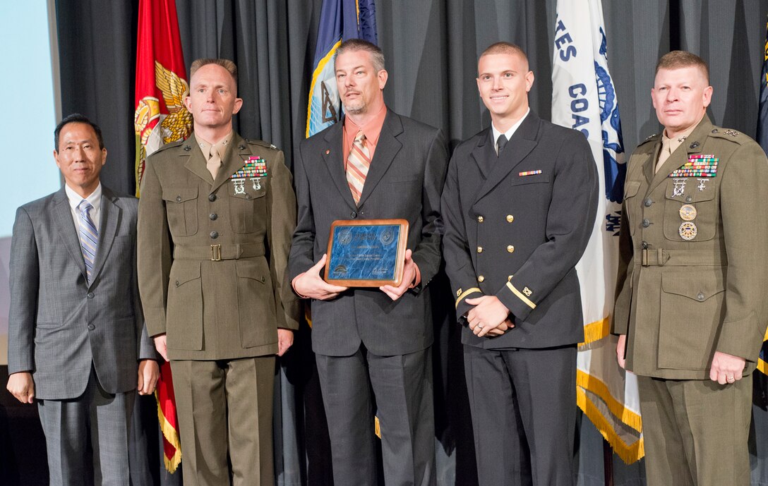 Officials from Marine Corps Base Camp Pendleton, as well as other Marine Corps and Navy officials are pictured receiving an award at the 2012 Secretary of the Na
vy Energy Awards Oct. 3. MCB Camp Pendleton received the Fiscal Year 2011 Energy and Water Management Award - Marine Corps Large Shore for its overall energy conservation and efficiency efforts. The ceremony was held at the U.S. Navy Memorial & Naval Heritage Center in Washington, D.C. Pictured from left to right are: The honorable Roger M. Natsuhara - Assistant Secretary of the Navy (Installations and Environment) (ASN (I&E)), Col. Robert S. Hellman - Assistant Chief of Staff G-F (Facilities), Marine Corps Installations West-Marine Corps Base Camp Pendleton, Jeff S. Allen - Energy Manager, Marine Corps Base Camp Pendleton, Ensign Mark A. Guida - Program Manager, Public Works Division (PWD), Marine Corps Base Camp Pendleton and Maj. Gen. James A. Kessler - Commander, Marine Corps Installations Command /Assistant Deputy Commandant for Installations and Logistics (Facilities).