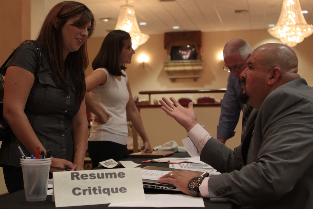 Transition deployment specialist Miguel Gonzalez critiques a resume from Angelique Melbourne, a military spouse from Newark, Calif., during a hiring fair hosted by the U.S. Chamber of Commerce at the Pacific Views Event Center here Oct. 11. (