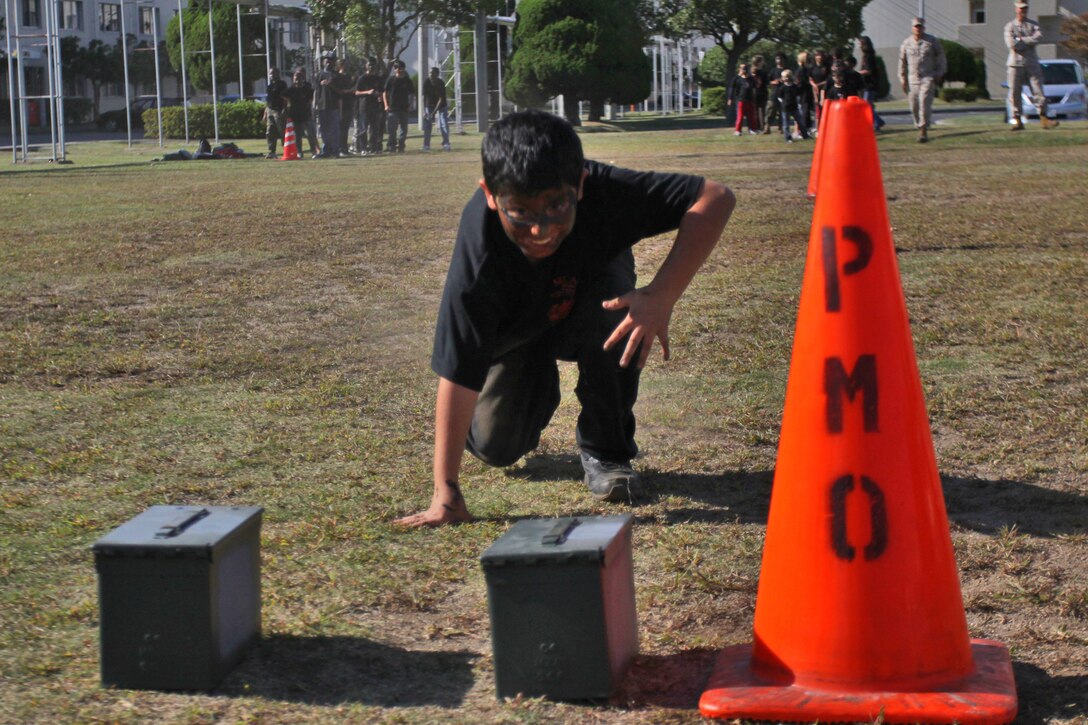 Orion Campos, 9, Young Warrior Day participant, prepares to pick up 10 pound ammo cans during a modified Combat Fitness Test at the Robert M. Casey Medical and Dental Clinic field here during Young Warrior Day Oct. 13, 2012. Young Warrior Day is an event which allows children to experience what their parents do as Marines.