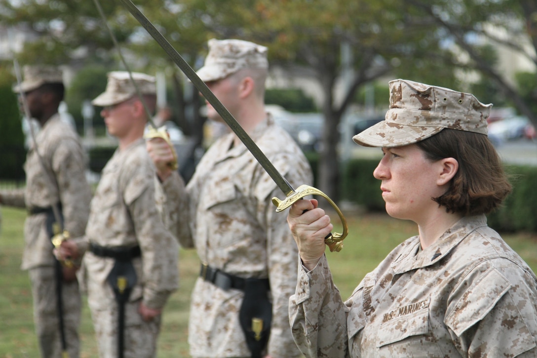 Cpl. Holly Andrews, Corporals Course class leader, maintains bearing while practicing sword manual on the parade deck across from Building One here Oct. 9, 2012. Marines are taught a variety of things throughout the course such as the importance of public speaking and how to lead physical training.