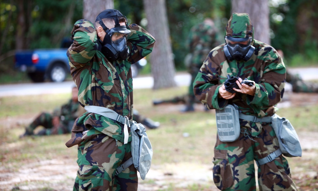 Marines with 2nd Marine Logistics Group take off their protective suits after completing a field survey with the AN/PDR-77, a device that detects and measures radiation, during a training exercise aboard Camp Lejeune, N.C., Oct. 17, 2012. Chemical, biological, radiological and nuclear defense specialists instructed the troops on how to use the equipment to detect and measure simulated radiation in contaminated situations throughout a four-day course.