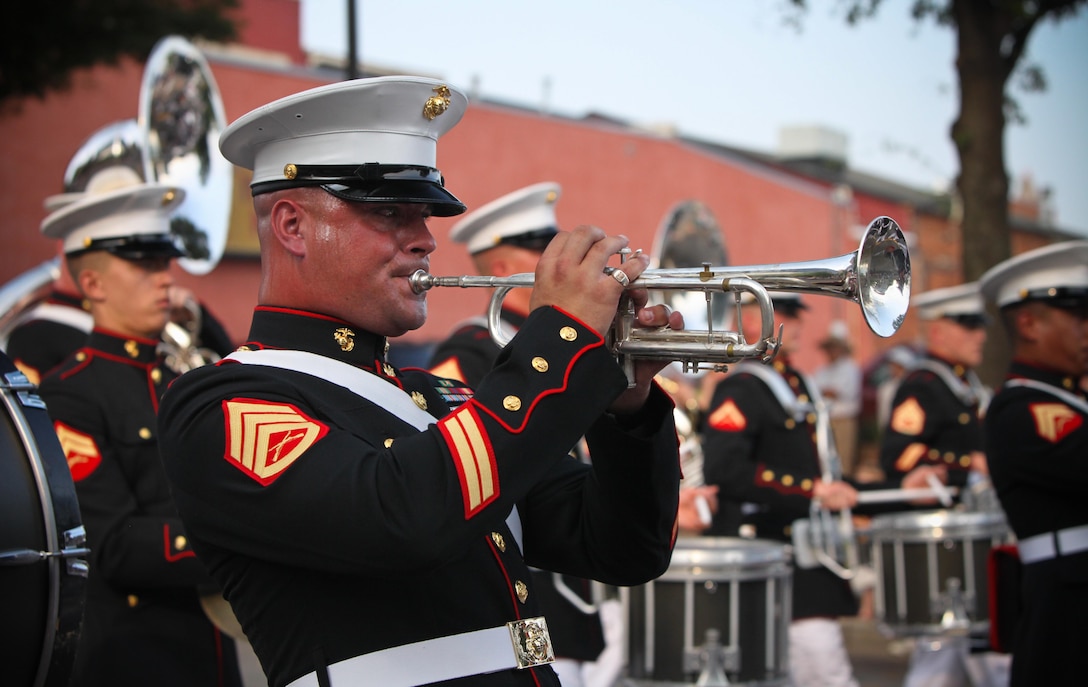 Staff Sgt. Steven Williams, a trumpet player with the 2nd Marine Division Band, plays the trumpet as the Band marches through downtown’s main street. Williams will be taking on the challenge of leading the Marine musicians as the assistant drum major for The President’s Own.
