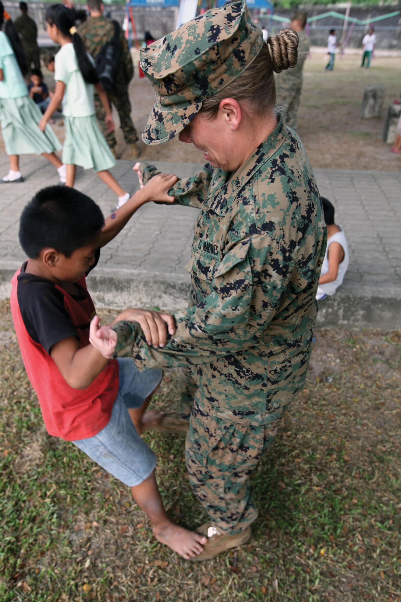 Sgt. Laura L. Fulz plays with a student from the Hanniel Christian Academy and Orphanage during a visit Oct. 11. Marines and sailors with the 31st Marine Expeditionary Unit took time out of their training schedule during PHIBLEX 2013 to visit the academy and orphanage and spend time with the children there. Fulz is a radio supervisor for the command element of the 31st MEU. 