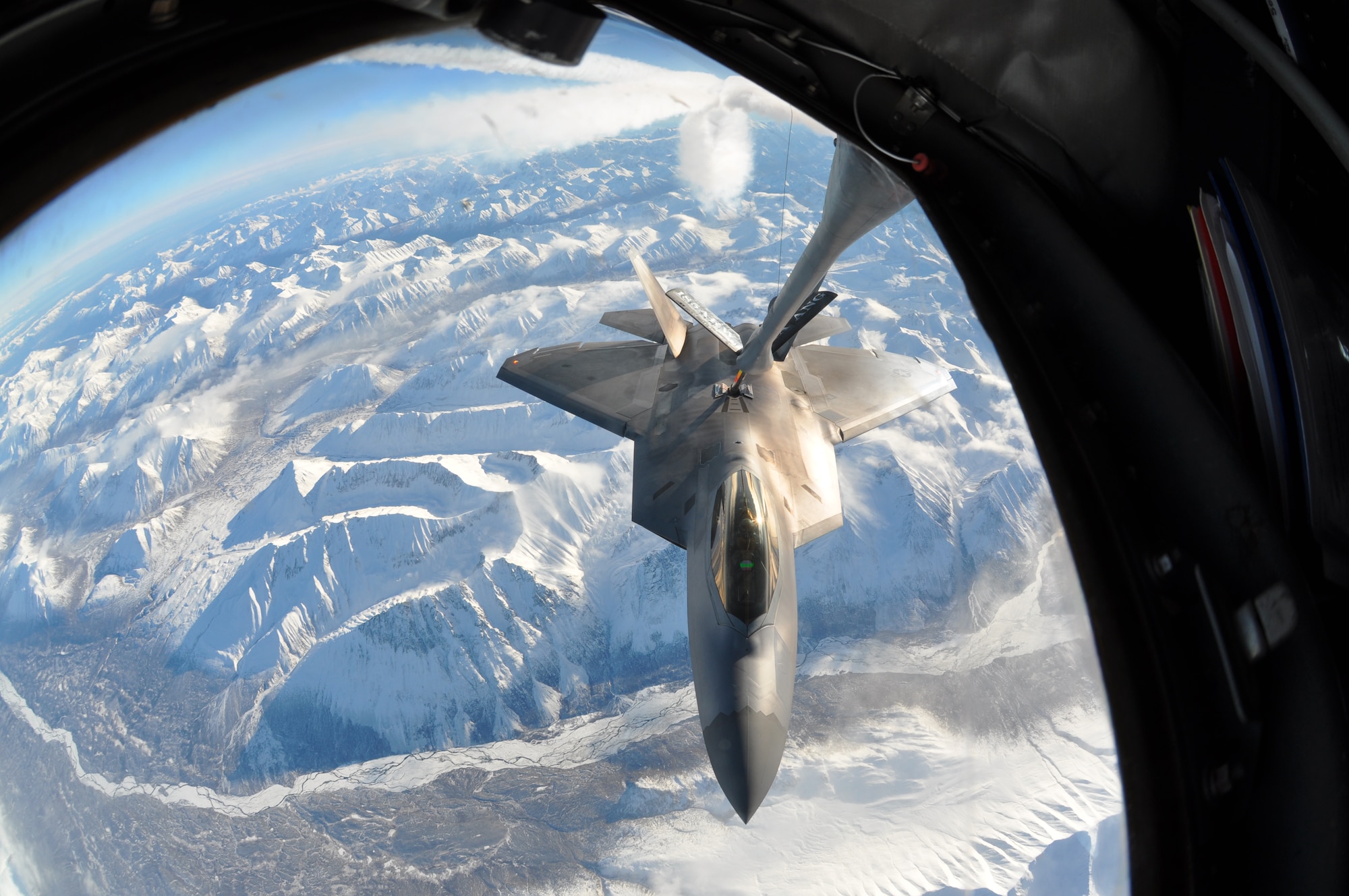 An F-22 assigned to the 3rd Wing receives gas from a KC-135 assigned to Iowa’s Air National Guard, 185th Air Refueling Wing. The KC-135 crew from Sioux City, Iowa spent a week in Alaska refueling active duty and Reserve F-22 pilots assigned to the 3rd Wing and 477th Fighter Group. In-flight refueling enables the Raptor pilots to fly longer sorties and farther distances. (U.S. Air Force Reserve/Capt. Ashley Conner) 