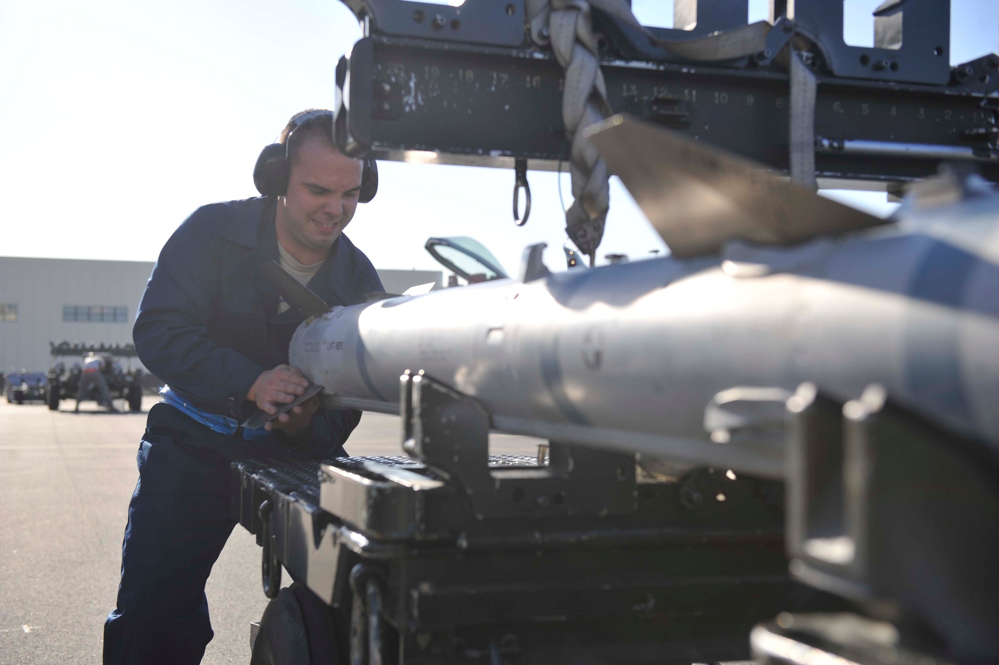 JOINT BASE ELMENDORF-RICHARDSON, Alaska -- Senior Airman Wesley Baird, 3rd Aircraft Maintenance Squadron load crew member, prepares to load a missile onto an F-22 Raptor aircraft during the annual load competition Oct. 17. The load competition is an event held to demonstrate the skill level and knowledge of all Joint Base Elmendorf-Richardson aircraft maintainers including active duty and Reserve Airmen. (U.S. Air Force photo/ Airman Ty-Rico Lea)