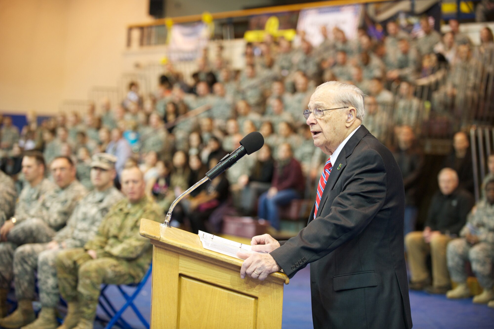 JOINT BASE ELMENDORF-RICHARDSON, Alaska --  Former Army Staff Sgt. Frank DeRosa, a World War II 793d Military Police Battalion veteran, delivers remarks before the battalion cases its colors. Soldiers of Headquarters and Headquarters Detachment, 793d MP marked an impending nine-month deployment to Afghanistan during an Oct. 12, 2012 deployment ceremony at JBER's Buckner Physical Fitness Center. HHD will function as the headquarters for other companies from other states, and the consolidated unit will be known as Task Force Spartan. (U.S. Air Force photo/David Bedard)