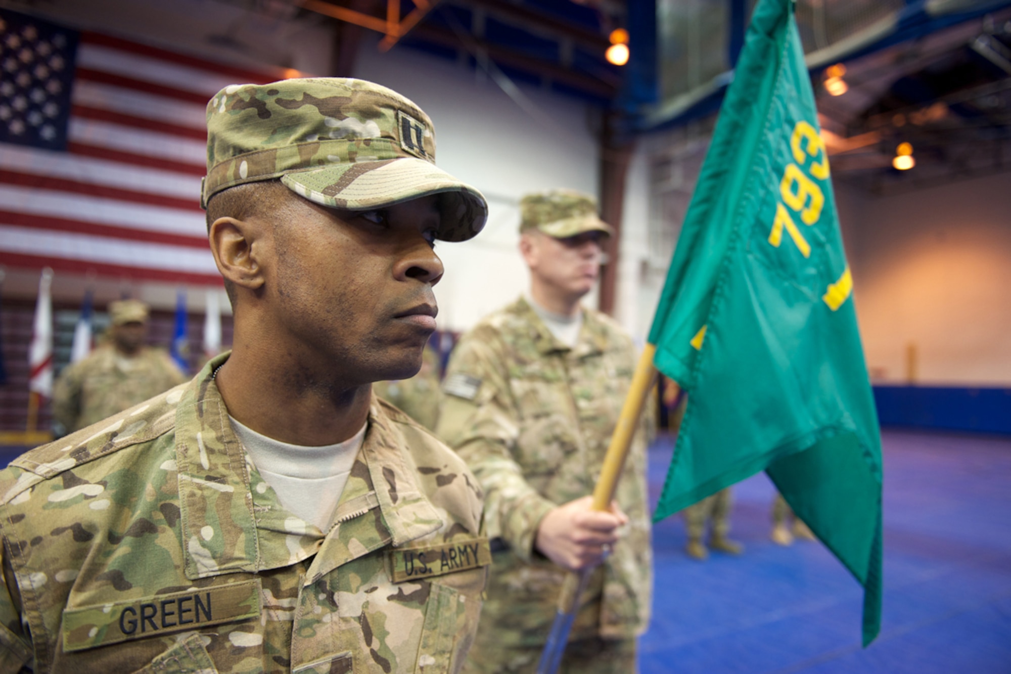 JOINT BASE ELMENDORF-RICHARDSON, Alaska --  Headquarters and Headquarters Detachment, 793d Military Police Battalion commander Army Capt. Robert Green, from Anchorage, stands ready while Pfc. Jacob Morris, from Broken Bow, Okla., bears the HHD guidon. Soldiers of HHD marked an impending nine-month deployment to Afghanistan during an Oct. 12, 2012 deployment ceremony at JBER's Buckner Physical Fitness Center. HHD will function as the headquarters for other companies from other states, and the consolidated unit will be known as Task Force Spartan. (U.S. Air Force photo/David Bedard)