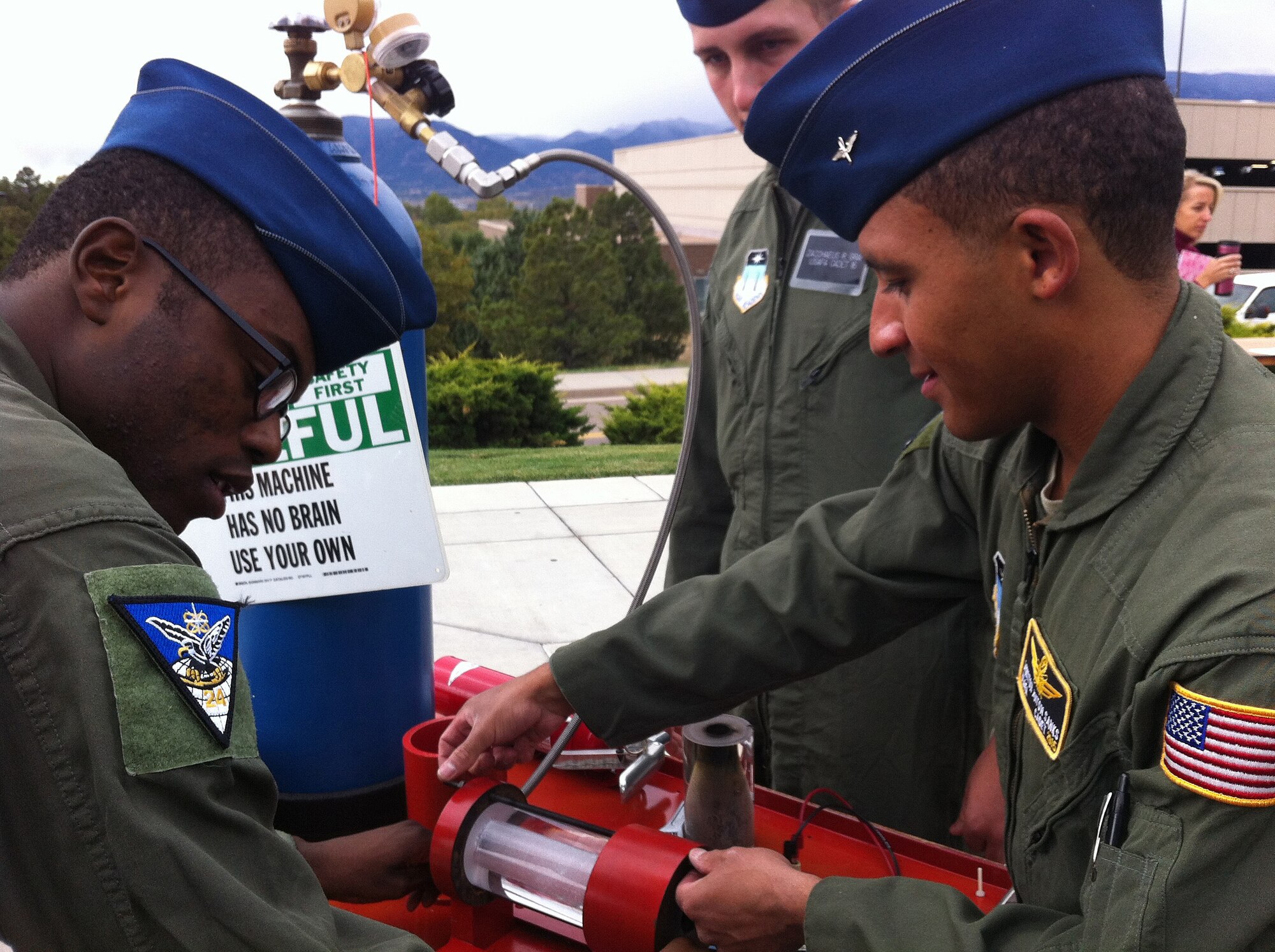Cadet 3rd Class Winston Sanks (right) helps set up a rocket demonstration at the University of Colorado - Colorado Springs Oct. 13, 2012. Sanks is the assistant cadet in charge for the Academy's Science, Technology, Engineering and Mathematics Club, which took part in the Colorado Springs Cool Science Carnival Oct. 13-14. (U.S. Air Force photo/Julie Imada)