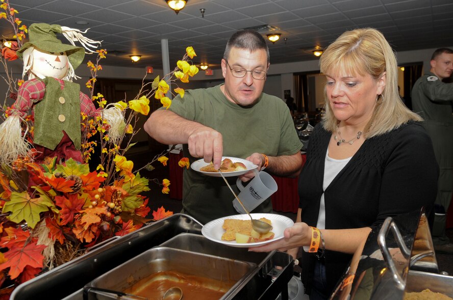 Army Sgt. 1st Class David Bailey and Tammy Walters, prepare their plates during the 5th annual Oktoberfest on Barksdale Air Force Base, La., Oct. 5. The buffet included authentic German foods such as schnitzel, bratwurst, sauerkraut, kartoffelsalat and pretzels. The festival is based on the traditional Oktoberfest, a 200 year-old festival held in Munich, Germany. (U.S. Air Force photo/Senior Airman Kristin High)(RELEASED)
