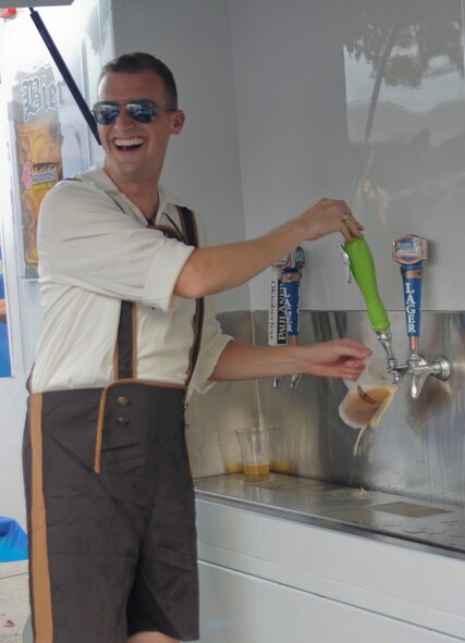 Capt. J. Alan Goddard, 2nd Operational Support Squadron weather flight commander, fills a stein during the 5th annual Oktoberfest on Barksdale Air Force Base, La., Oct. 5. Patrons purchased tickets for the event which included two beverages, an authentic German meal and a commemorative stein. (U.S. Air Force photo/Senior Airman Kristin High)(RELEASED)
