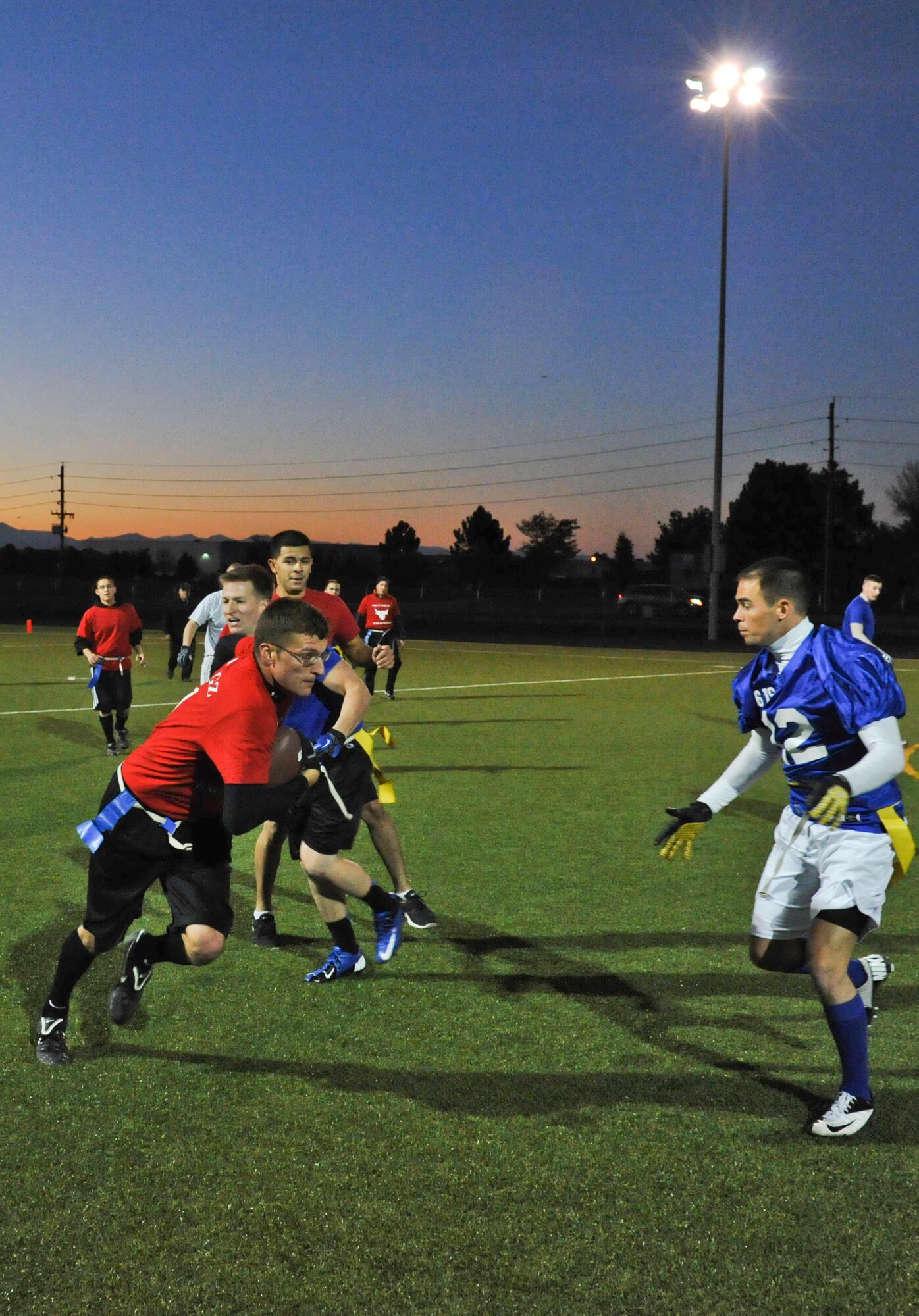 BUCKLEY AIR FORCE BASE, Colo. – Jayce Yeager, 460th Civil Engineer Squadron, tries to weave his way through 566th Intelligence Squadron defenders during an intramural football game Oct. 17. 566 IS won the game with a score of 27-6 improving their record to 7-4 while CES fell to 2-6. Yeager had the only touchdown reception of the game for CES. (U.S. Air Force photo by Senior Airman Christopher Gross)