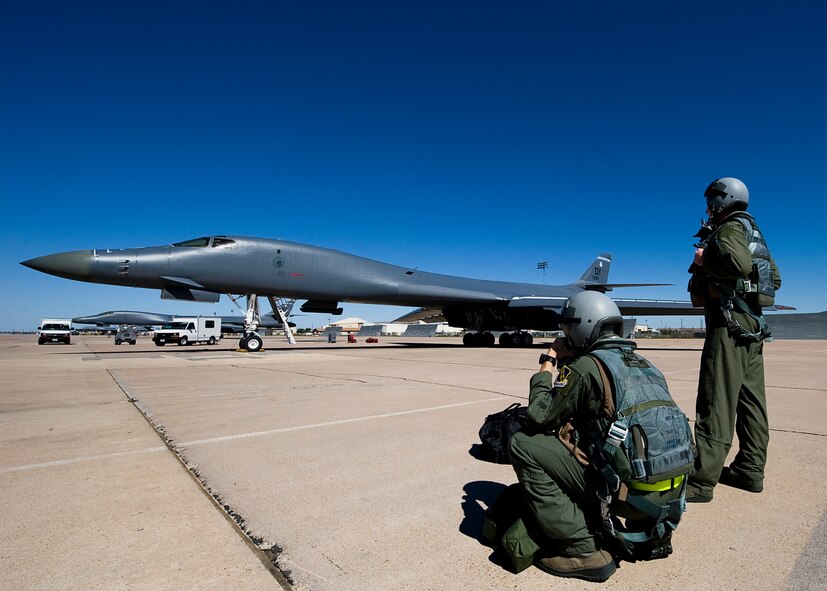 Members of the 9th Bomb Squadron standby as final preparations for a B-1 Bomber are complete Oct. 17, 2012, during an Operational Readiness Exercise at Dyess Air Force Base, Texas. For three days Team Dyess was tested on their ability to deploy personnel and assets to a deployed location in support of combatant commanders during an ORE Oct. 15-17. During this exercise, known as a Phase I ORE, Dyess was evaluated on the wing’s ability to prepare and mobilize from peacetime readiness to a wartime posture on short notice. Areas evaluated included command and control, deployment processing, employment readiness, information operations and force protection. (U.S. Air Force photo by Airman 1st Class Damon Kasberg/ Released)