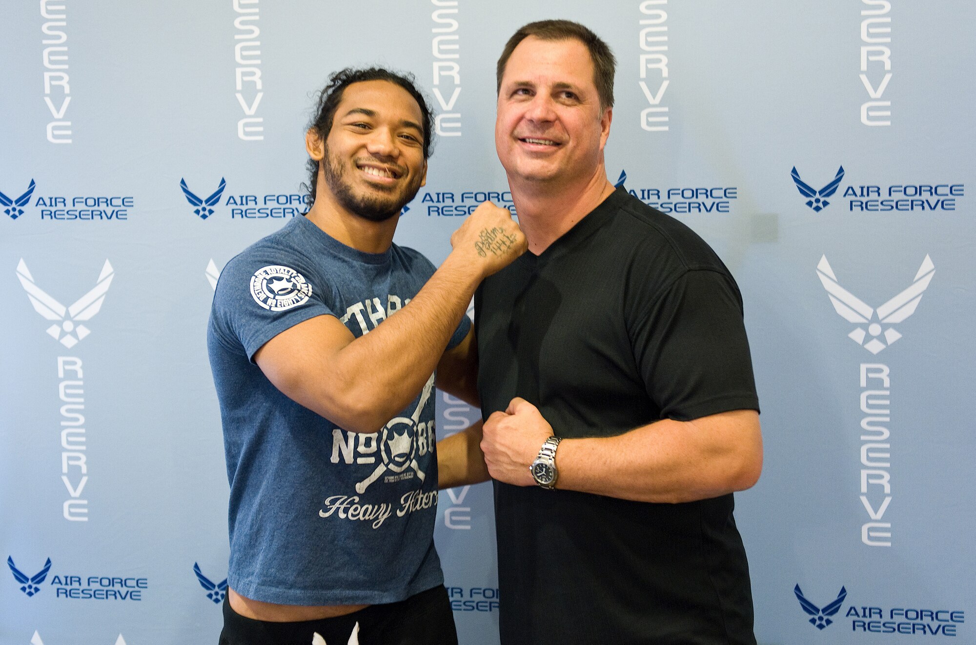 Ben Henderson, the current Ultimate Fighting Championship lightweight champ, has some fun with Lt. Col. Andrew Eiler, 512th Operations Support Flight commander, Oct. 13, 2012, before the 512th Airlift Wing's Mass Enlistment Ceremony held at a mixed martial arts event in Dover, Del. Henderson is one of many UFC fighters featured at Air Force Reserve recruiting events around the world. (U.S. Air Force photo/Roland Balik)