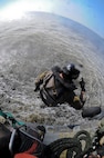 U.S. Air Force Staff Sgt. Justin Tyler, 38th Rescue Squadron pararescueman, freefalls from an HH-60G Pave Hawk into the Gulf of Mexico during water operations training, Oct. 11, 2012. The training allowed Tyler and Pave Hawk aircrew from the 41st Rescue Squadron to practice various rescue scenarios they might encounter in real-world situations. (U.S. Air Force photo by Staff Sgt. Joshua J. Garcia/Released)  